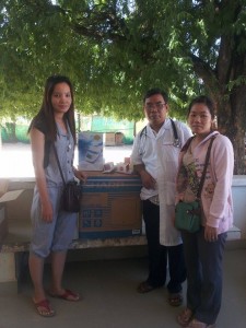 Ramya Moang presenting Dr Nourn Sophat and Midwife with a refrigerator for the Maternity area.